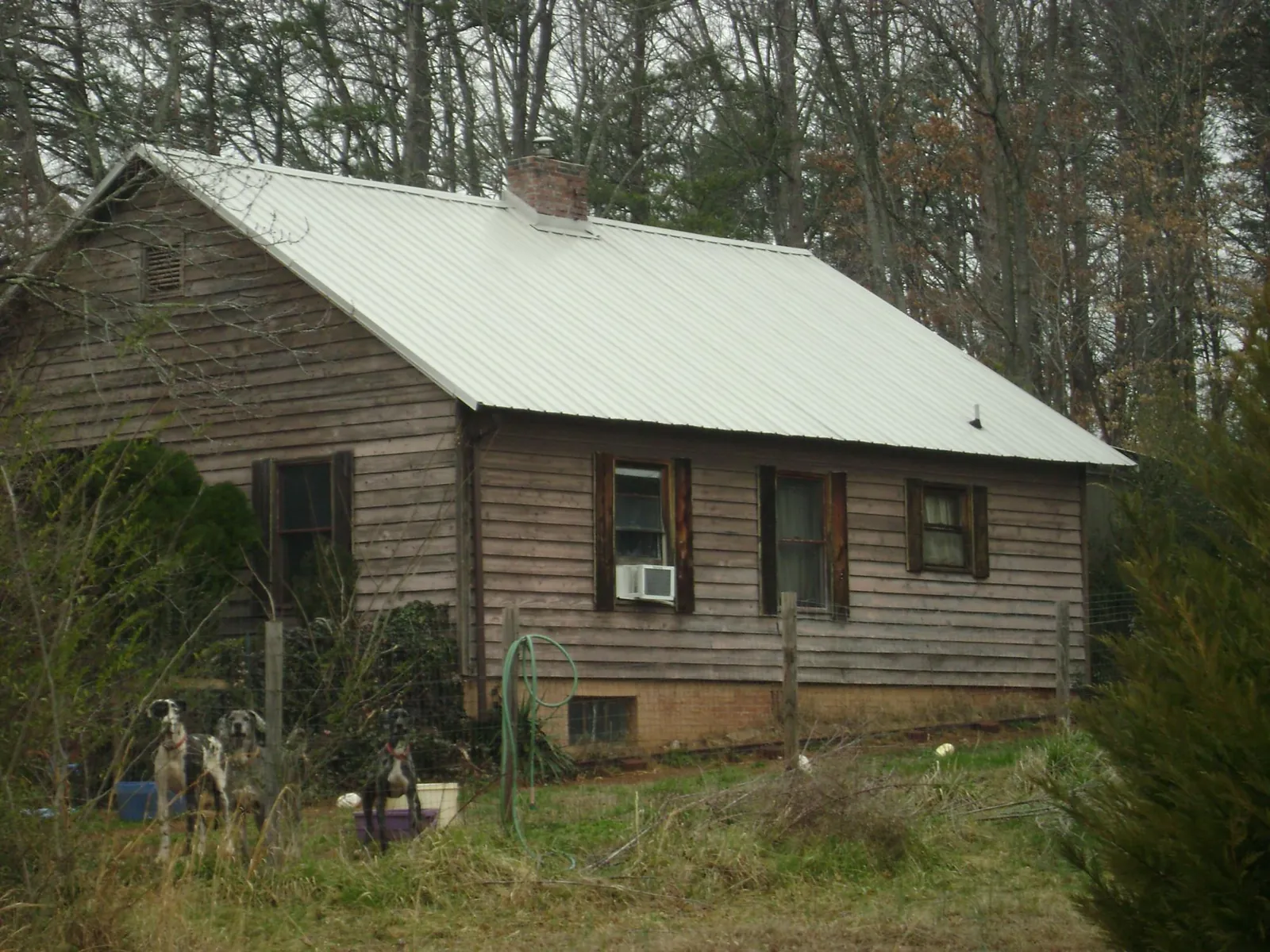 White metal roof on an old wood sided farmhouse in Harrisville